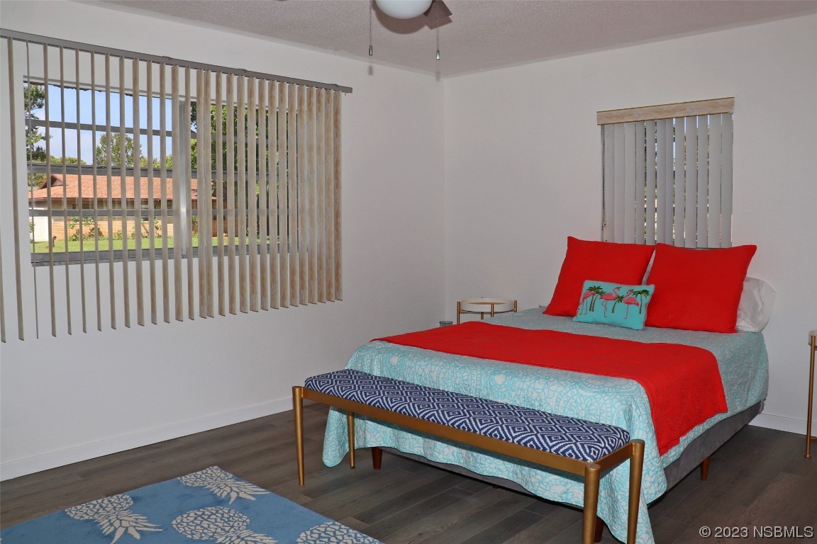 10 Raintree Drive Port Orange, FL 32127 - Photo 13 of 31 a bedroom with a bed and wooden floor