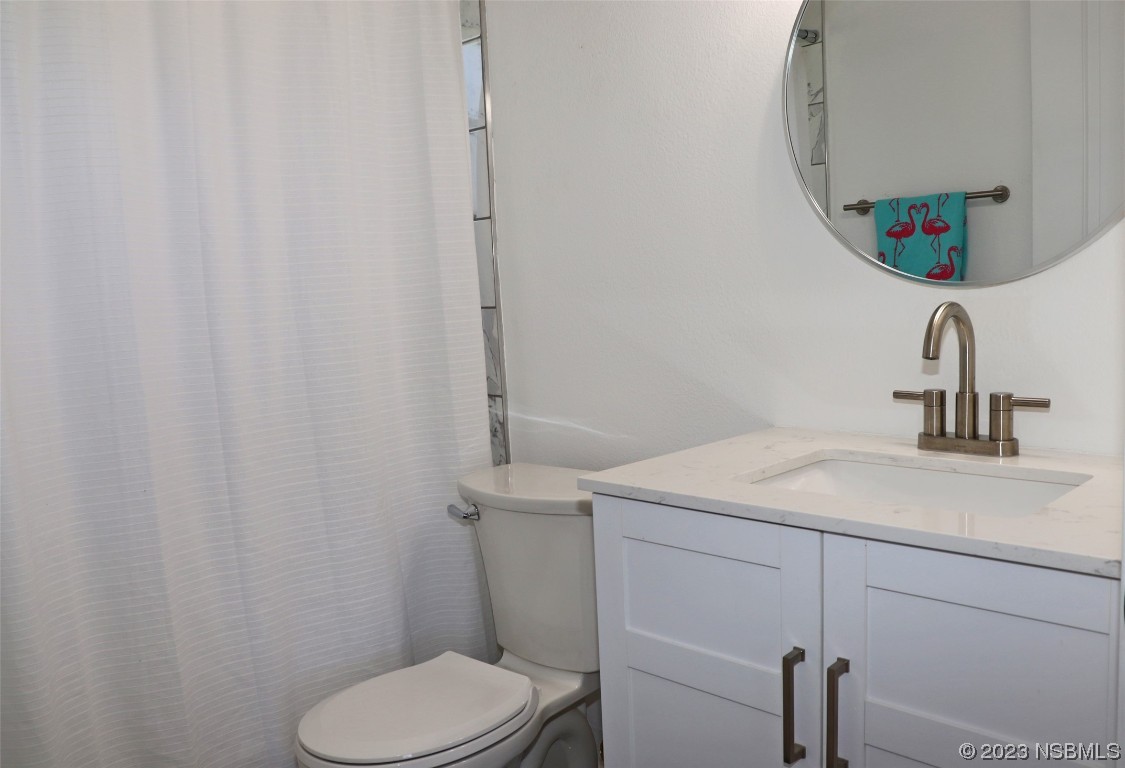 10 Raintree Drive Port Orange, FL 32127 - Photo 20 of 31 a bathroom with a sink toilet and mirror
