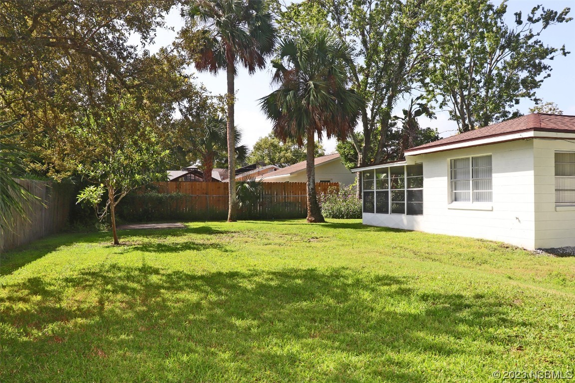 10 Raintree Drive Port Orange, FL 32127 - Photo 26 of 31 a backyard of a house with yard and tree