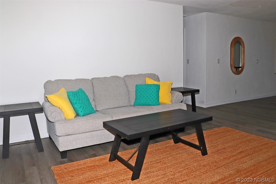 10 Raintree Drive Port Orange, FL 32127 - Photo 3 of 31 a living room with a couch and a wooden floor
