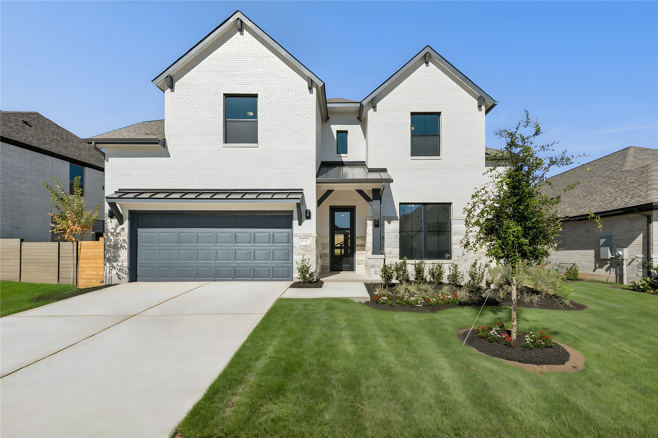 1520 Rodeo Ridge Drive Georgetown, TX 78628 - Photo 25 of 29 Modern farmhouse style home with a standing seam roof, an attached garage, concrete driveway, a metal roof, and brick siding