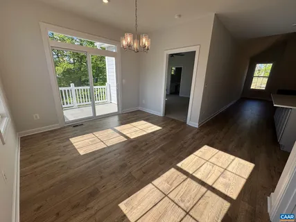 a view of wooden floor and windows in an empty room