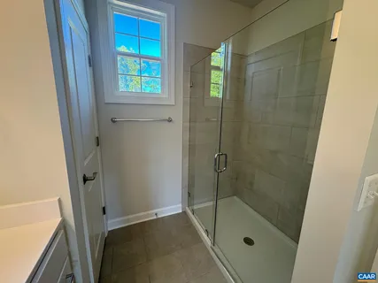 a bathroom with a shower and a window