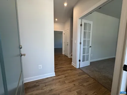 a view of a hallway with wooden floor