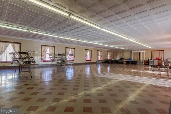 a room with pool table and windows