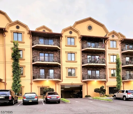 a front view of a residential apartment building with a yard