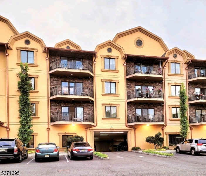 10 Lower Notch Road, Unit 11 Woodland Park, NJ 07424 - Photo 1 of 37 a front view of a residential apartment building with a yard