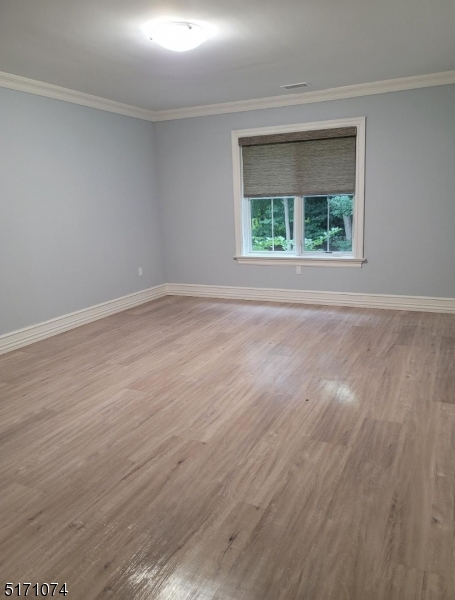 10 Lower Notch Road, Unit 11 Woodland Park, NJ 07424 - Photo 13 of 37 a view of an empty room with wooden floor and a window