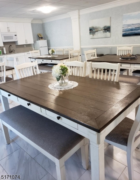 10 Lower Notch Road, Unit 11 Woodland Park, NJ 07424 - Photo 23 of 37 a kitchen with kitchen island a sink stove and wooden cabinets