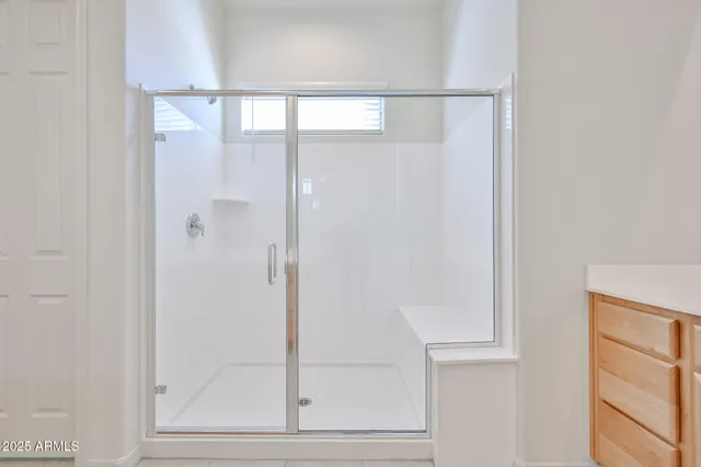a bathroom with a glass shower door