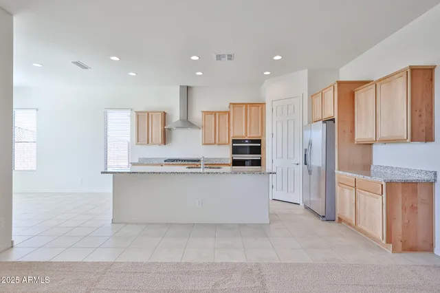 a large kitchen with a large counter top appliances and cabinets