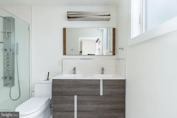 a bathroom with a toilet and shower
