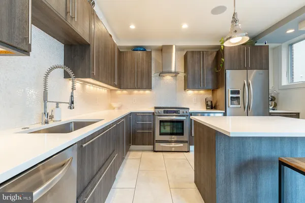 a kitchen with a refrigerator a sink and cabinets