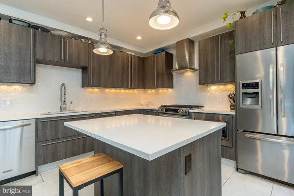 a kitchen with a refrigerator stove and microwave