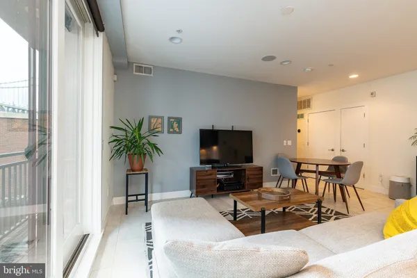 a kitchen with kitchen island a table and chairs