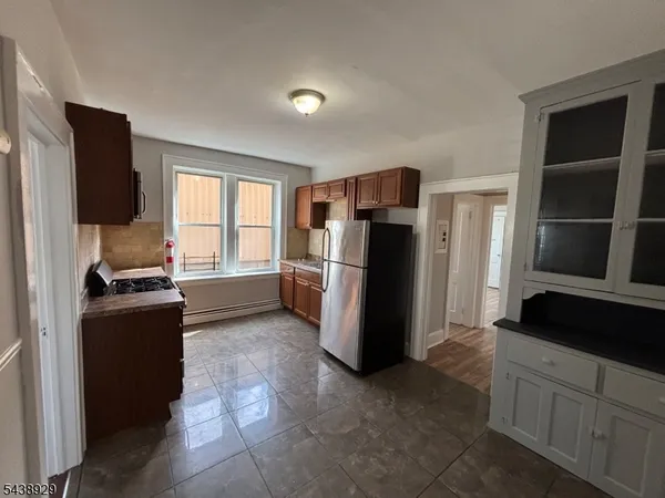 a kitchen with a refrigerator and a stove top oven