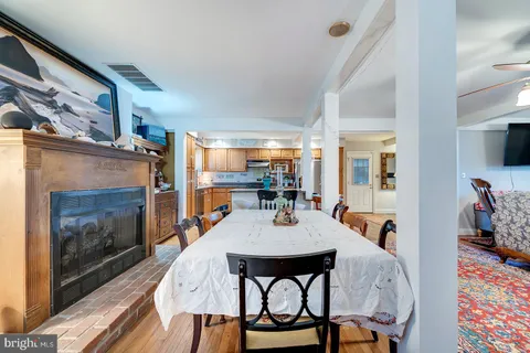 a dining room with furniture a rug and wooden floor
