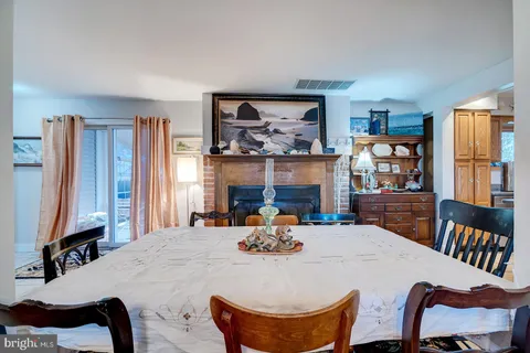 a view of a kitchen with a refrigerator and wooden floor