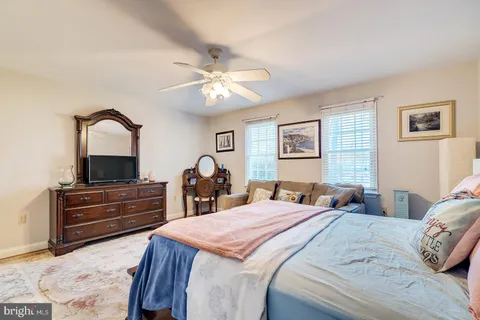 a bathroom with a toilet sink vanity and mirror