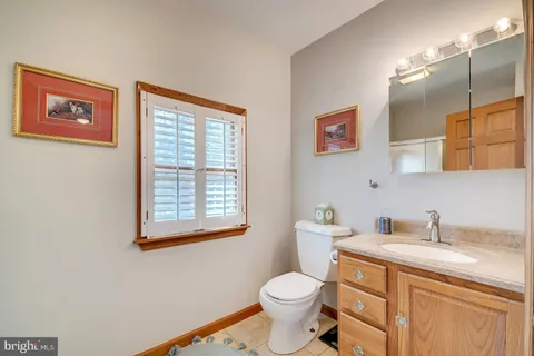 a front view of a house with a yard and potted plants