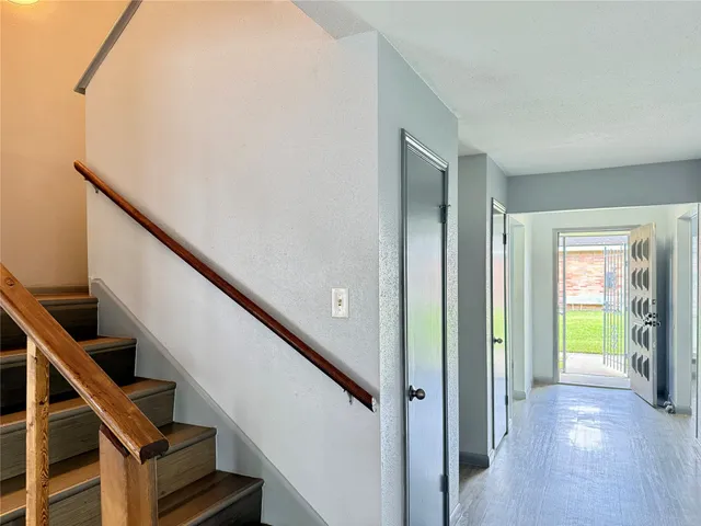 a view of an entryway with wooden floor and stairs