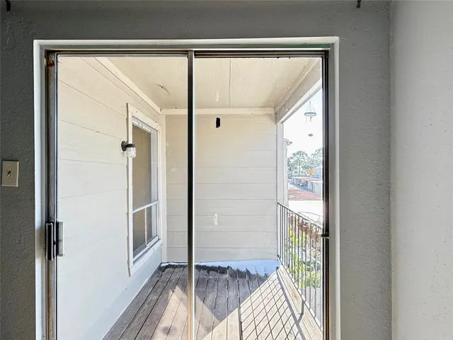 a view of a balcony with wooden floor