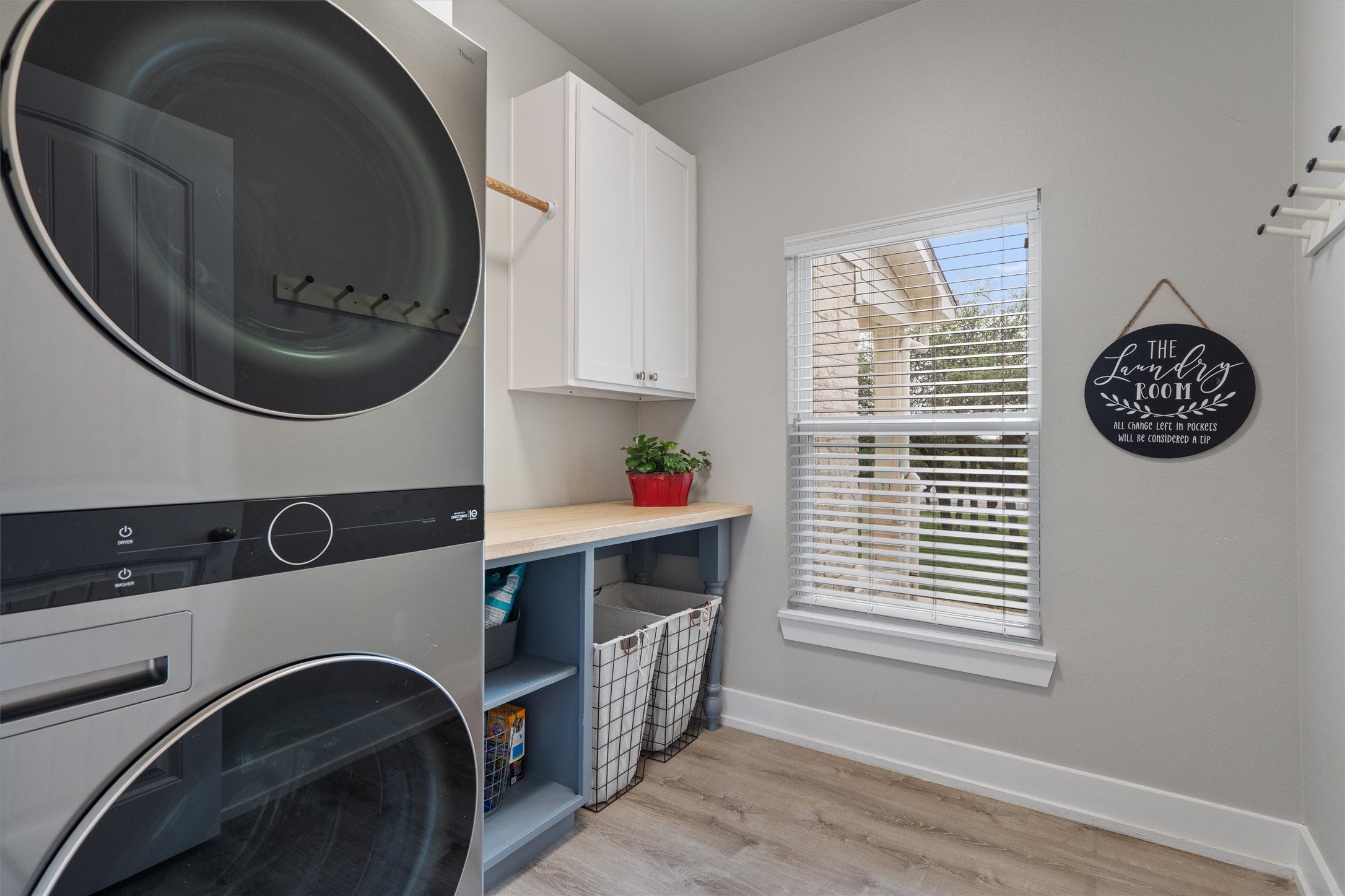 13105 Rooster Springs Road Austin, TX 78737 - Photo 19 of 38 The utility room features a stacked washer and dryer, however can accommodate side by side as well. Upper cabinetry, shelving, and a window with blinds