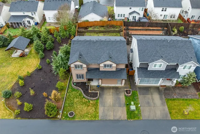 an aerial view of a house with yard swimming pool and outdoor seating