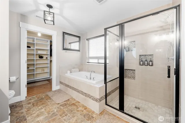 a bathroom with a bathtub and a shower