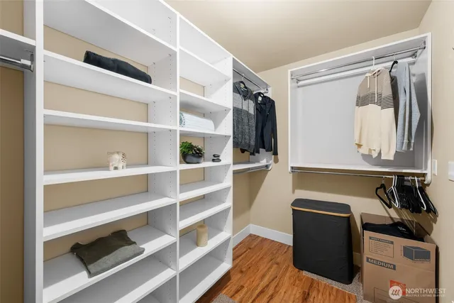 a view of walk in closet with clothes and shoes