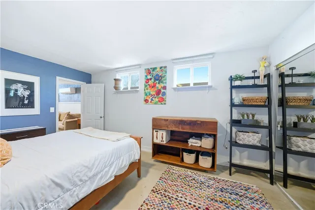 a bedroom with a bed a dresser and book shelf