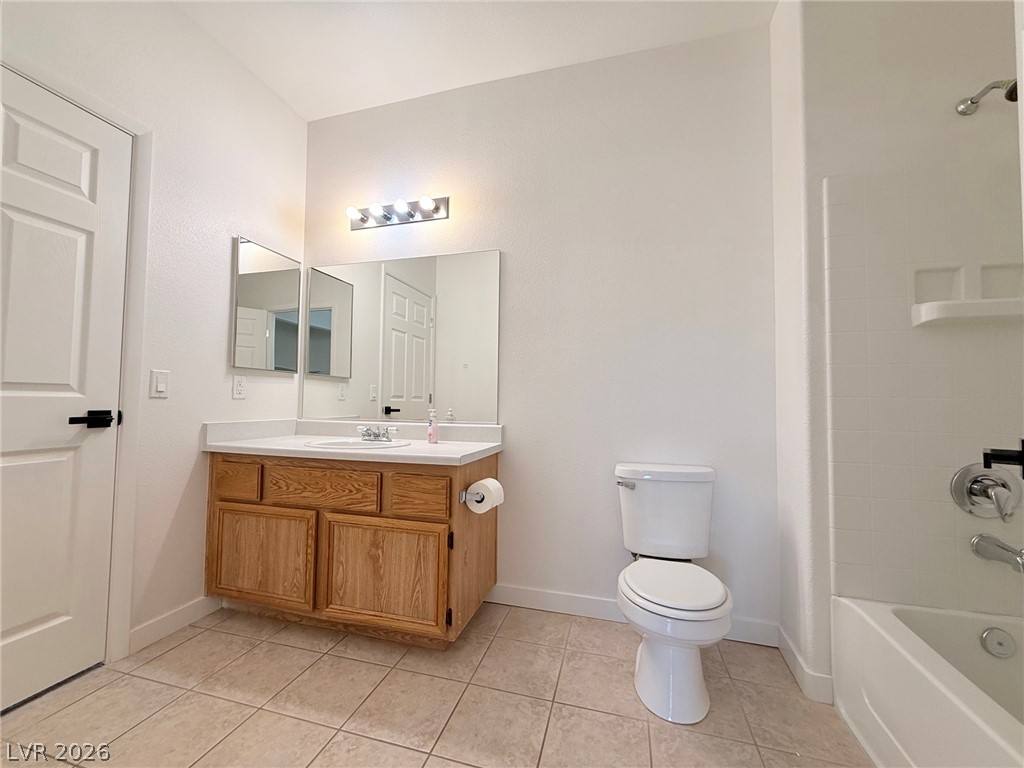 9050 West Warm Springs Road, Unit 2002 Las Vegas, NV 89148 - Photo 35 of 46 This bright bathroom features a vanity, toilet, and a tiled shower-tub combination.