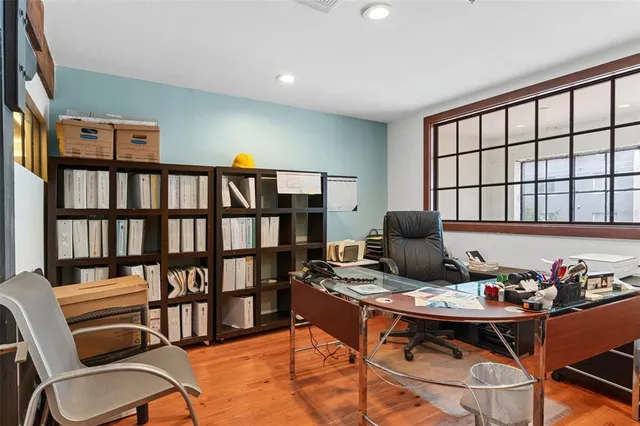 a view of a workspace with furniture and a potted plant