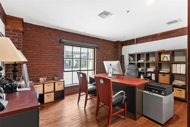 a living room with furniture a fireplace and wooden floor