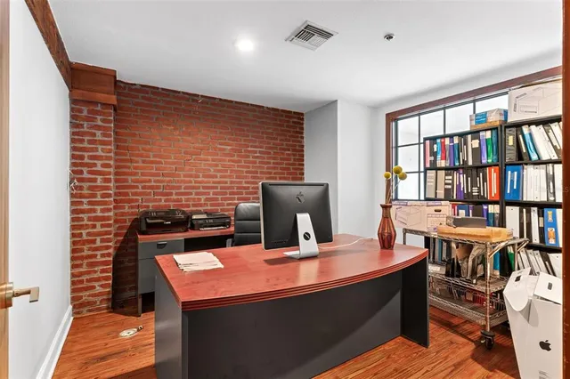 a living room with furniture and wooden floors