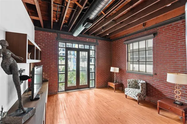 a living room with lots of wooden furniture and a window