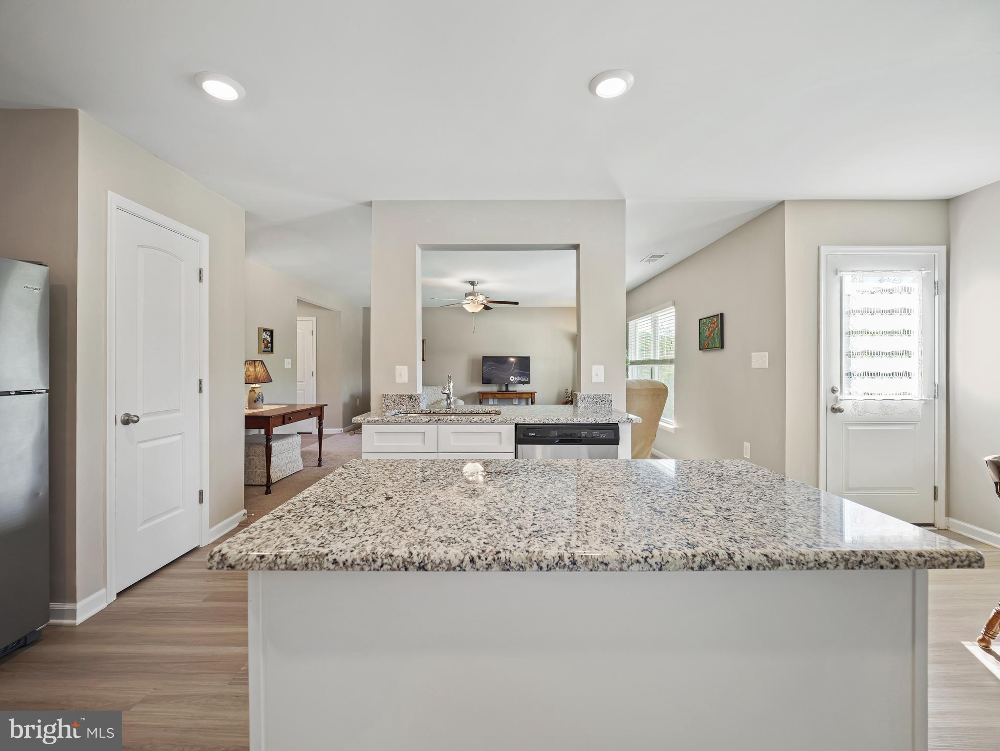 104 Rappahannock Run Falling Waters, WV 25419 - Photo 11 of 41 a living room with granite countertop couches and fireplace with wooden floor