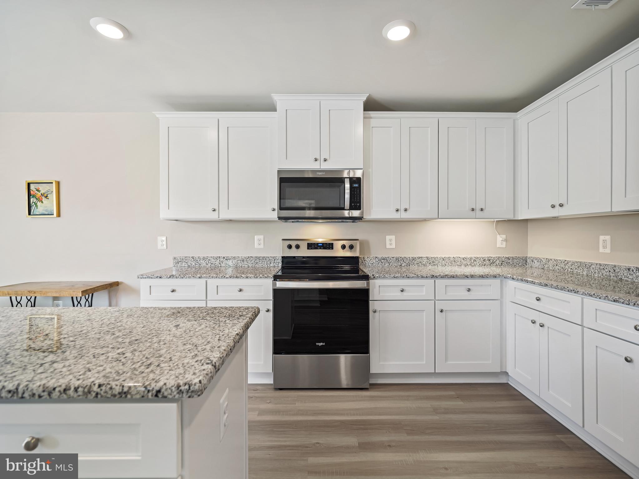 104 Rappahannock Run Falling Waters, WV 25419 - Photo 12 of 41 a kitchen with granite countertop white cabinets and stainless steel appliances