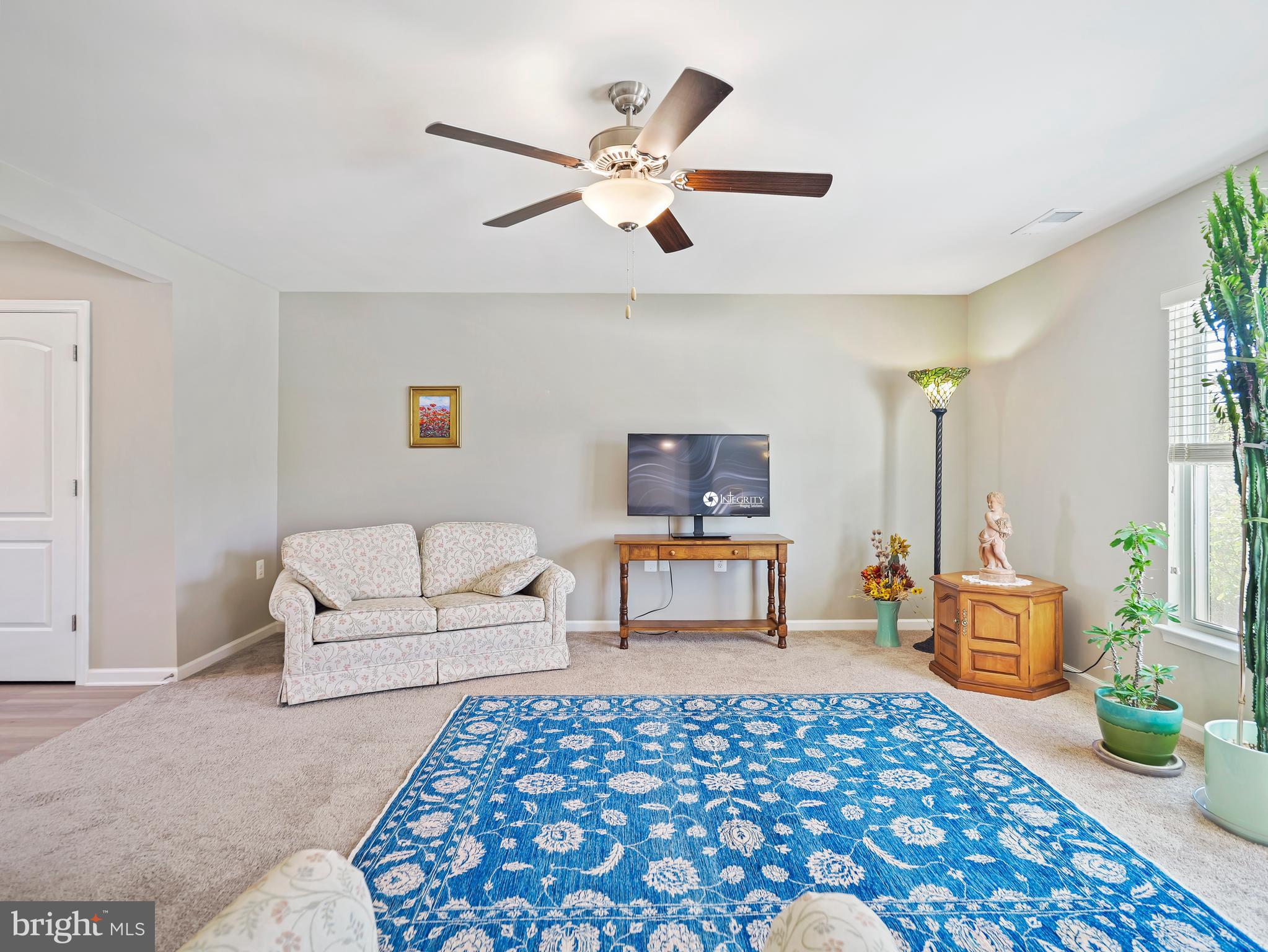 104 Rappahannock Run Falling Waters, WV 25419 - Photo 21 of 41 a living room with furniture and a table