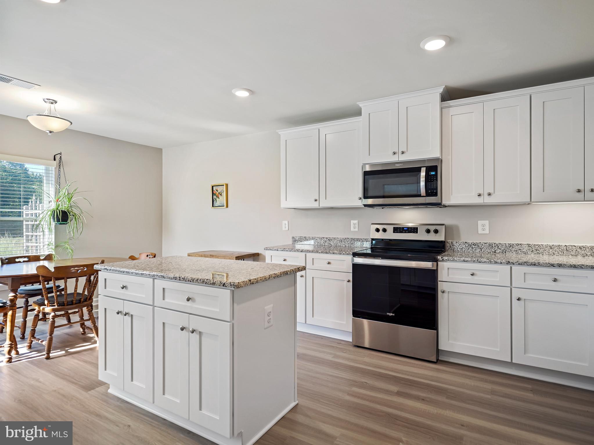 104 Rappahannock Run Falling Waters, WV 25419 - Photo 7 of 41 a kitchen with stainless steel appliances granite countertop a stove top oven a sink a counter top space and cabinets