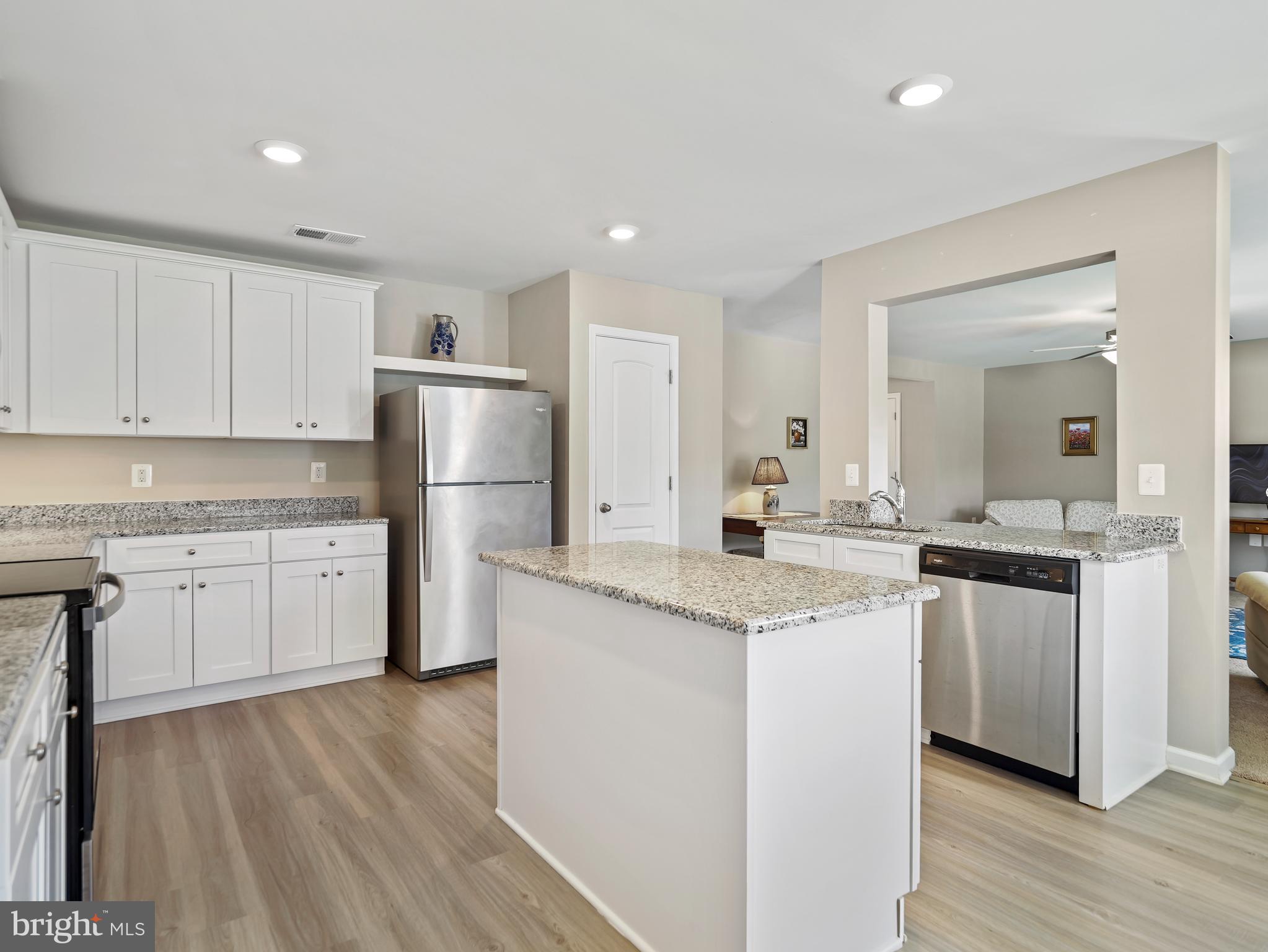 104 Rappahannock Run Falling Waters, WV 25419 - Photo 9 of 41 a kitchen with a sink a refrigerator and white cabinets
