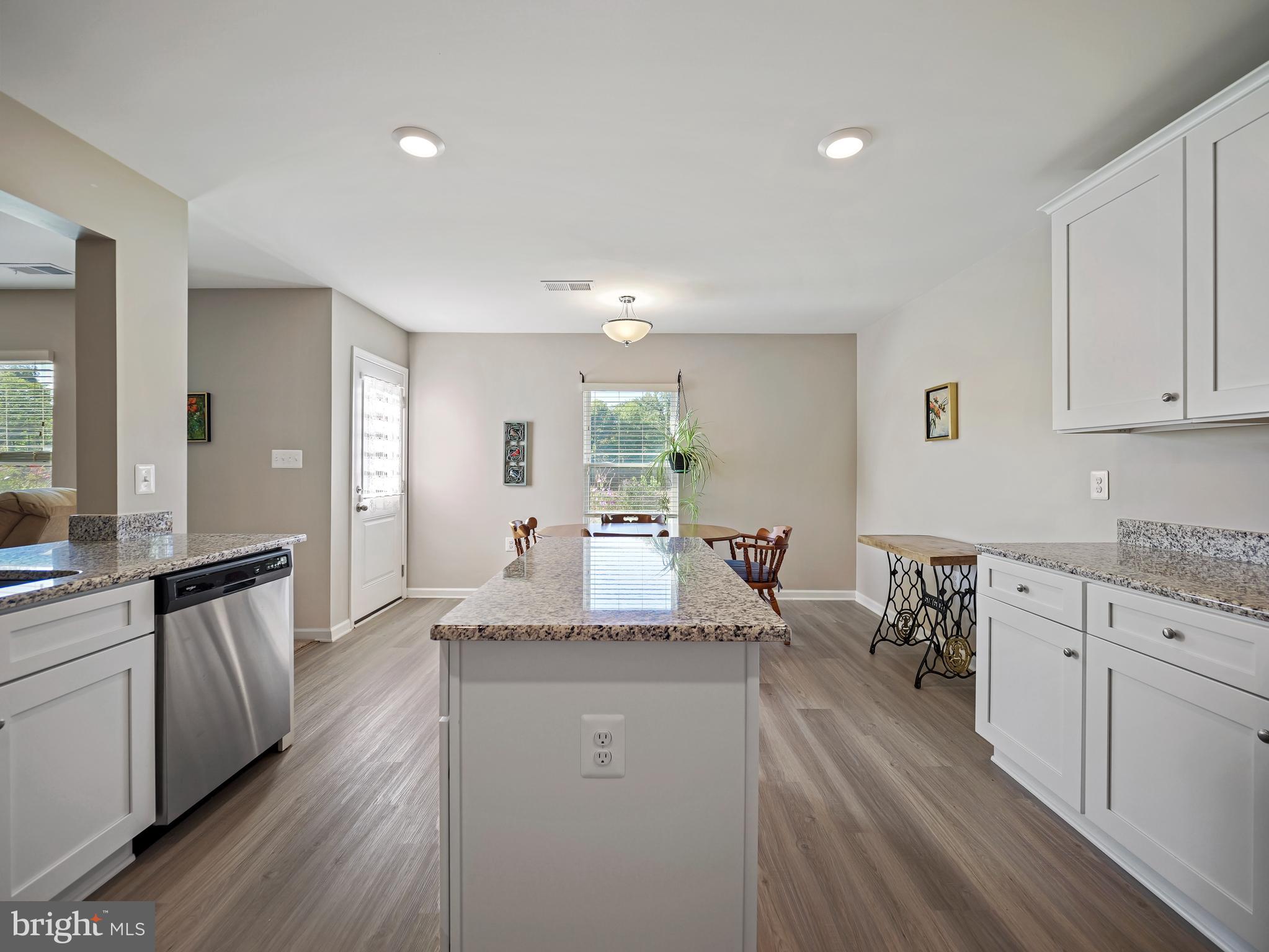 104 Rappahannock Run Falling Waters, WV 25419 - Photo 10 of 41 a large kitchen with granite countertop a large counter top space a sink a window and stainless steel appliances