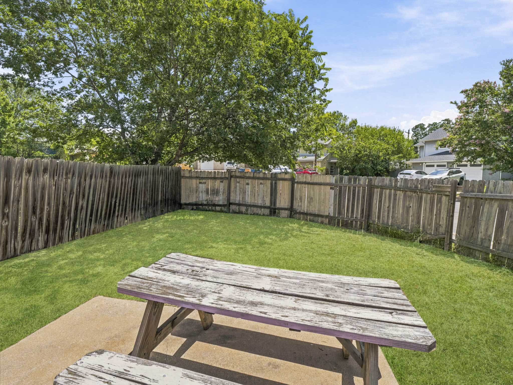 2401 Burleson Road Austin, TX 78741 - Photo 19 of 25 A fully fenced backyard offers a private green oasis with space for outdoor dining.