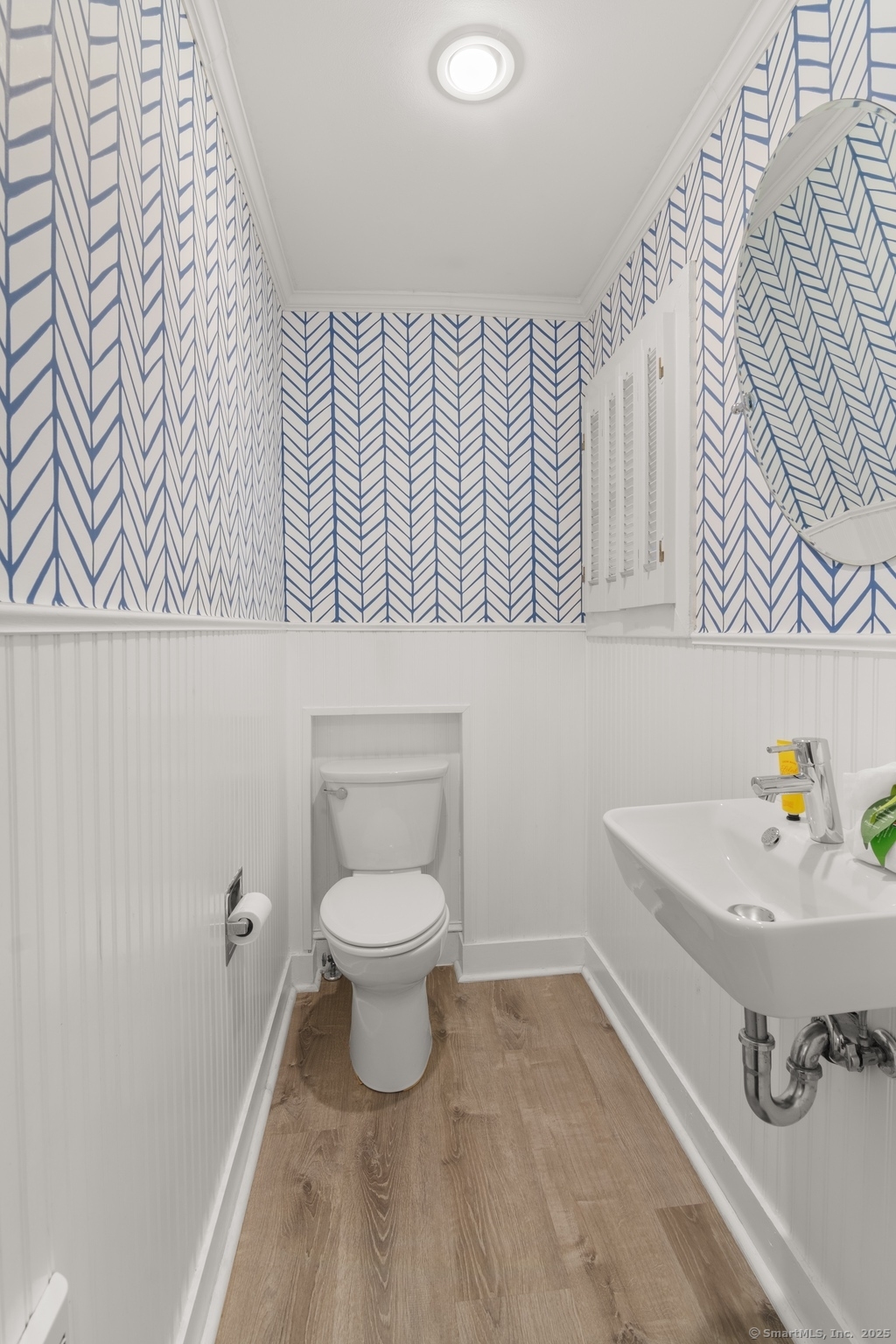 223 Middlesex Road Darien, CT 06820 - Photo 11 of 24 a bathroom with a sink a toilet and a shower curtain