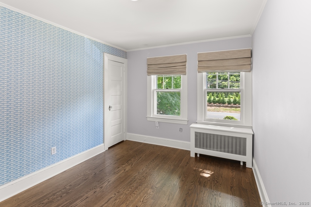 223 Middlesex Road Darien, CT 06820 - Photo 12 of 24 a view of an empty room with wooden floor and a window