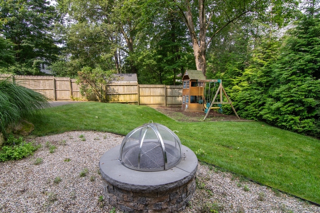 223 Middlesex Road Darien, CT 06820 - Photo 21 of 24 a view of a backyard with plants and trees