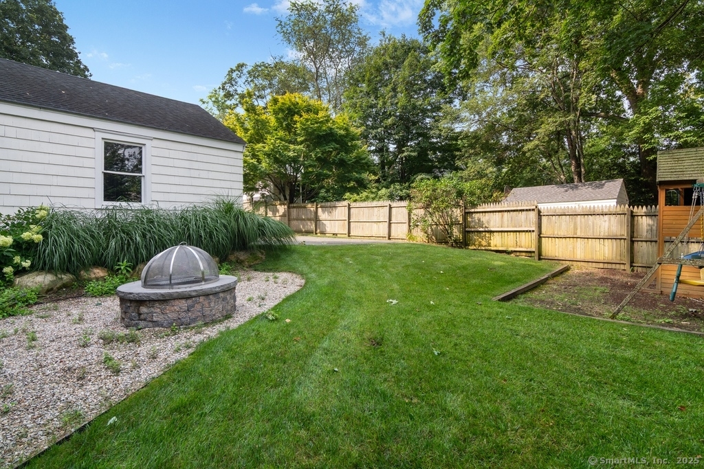 223 Middlesex Road Darien, CT 06820 - Photo 22 of 24 a view of a backyard with table and chairs and a barbeque