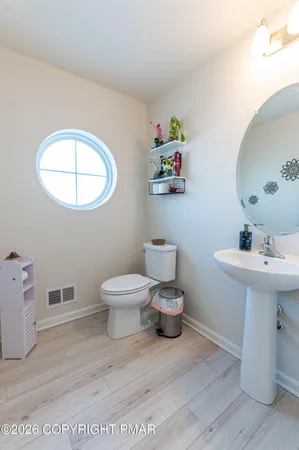 a bathroom with a sink toilet and a mirror