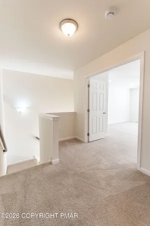 an empty room with closet and windows