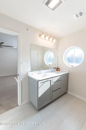 a view with a bathroom with a sink and a mirror